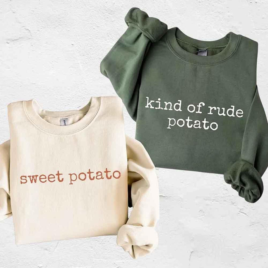 May include a pair of matching Thanksgiving-themed sweatshirts featuring the playful “Sweet Potato” and “Rude Potato” designs. The cozy crew necks are styled in warm fall colors, making them a fun and festive choice for couples during the autumn and holiday season.