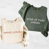 May include a pair of matching Thanksgiving-themed sweatshirts featuring the playful “Sweet Potato” and “Rude Potato” designs. The cozy crew necks are styled in warm fall colors, making them a fun and festive choice for couples during the autumn and holiday season.