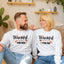 Two people sitting on a couch wearing matching 'Thankful' sweatshirts with text and graphics.