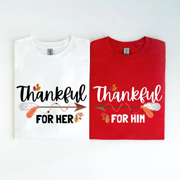 Two folded shirts, one white and one red, with 'Thankful for Her' and 'Thankful for Him' text.