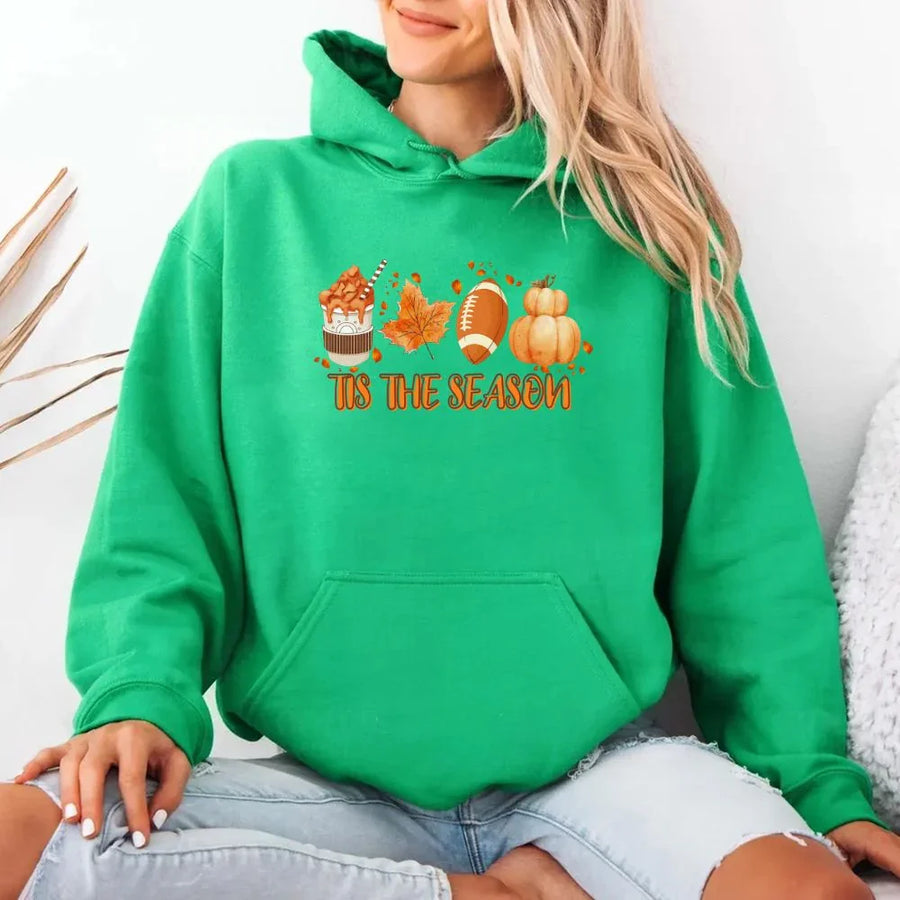 Person wearing a green hoodie with 'It's the Season' text and graphics on a white background