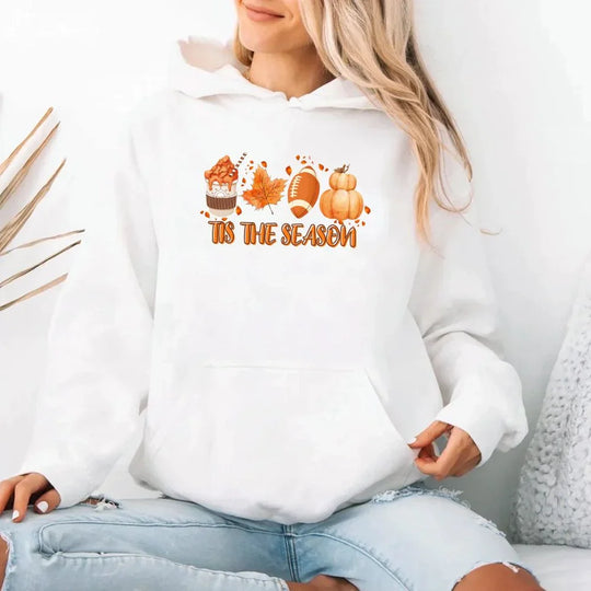 White hoodie with 'It's the Season' text and pumpkins design, worn by a person.