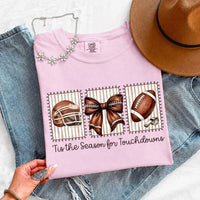 May include a Comfort Colors T-shirt featuring a 'Tis the Season for Touchdowns football-inspired design, perfect for football fans, game days, tailgates, and holiday gatherings.