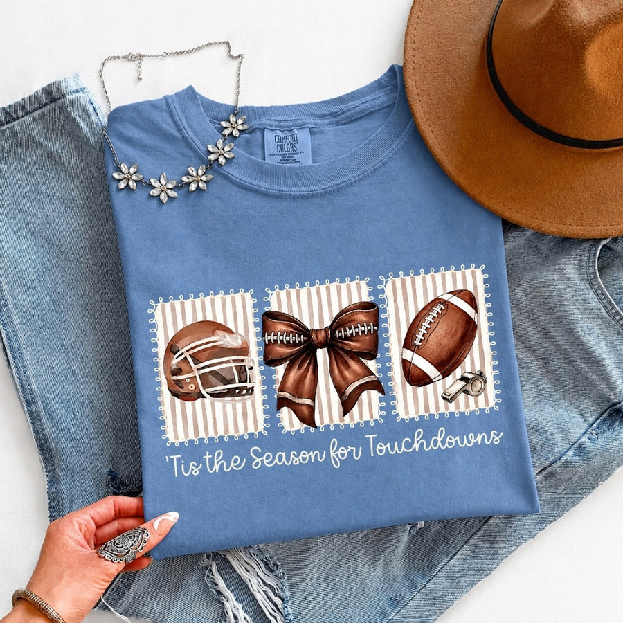 May include a Comfort Colors T-shirt featuring a 'Tis the Season for Touchdowns football-inspired design, perfect for football fans, game days, tailgates, and holiday gatherings.