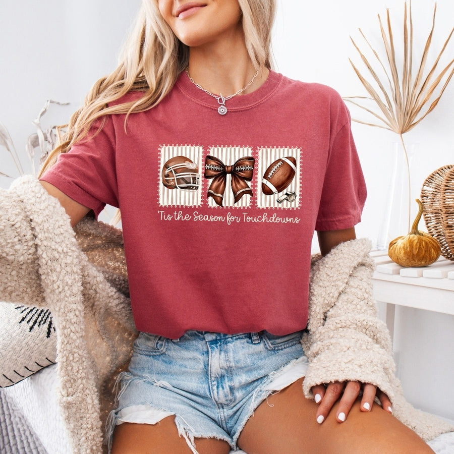 May include a Comfort Colors T-shirt featuring a 'Tis the Season for Touchdowns football-inspired design, perfect for football fans, game days, tailgates, and holiday gatherings.