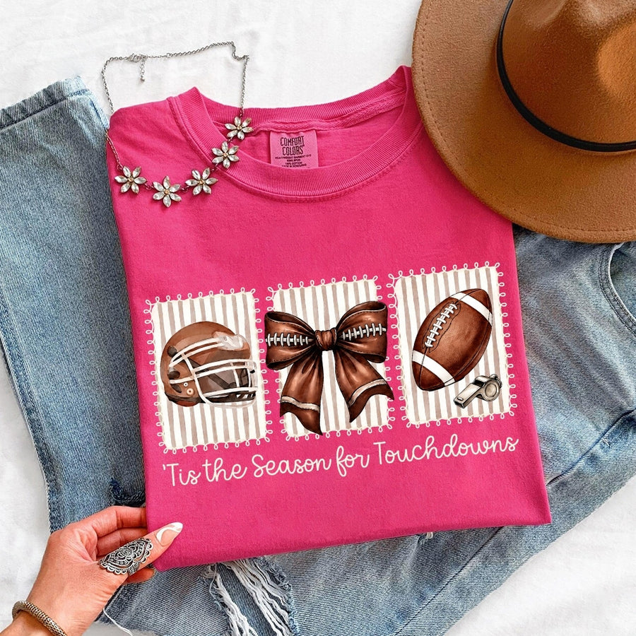 May include a Comfort Colors T-shirt featuring a 'Tis the Season for Touchdowns football-inspired design, perfect for football fans, game days, tailgates, and holiday gatherings.