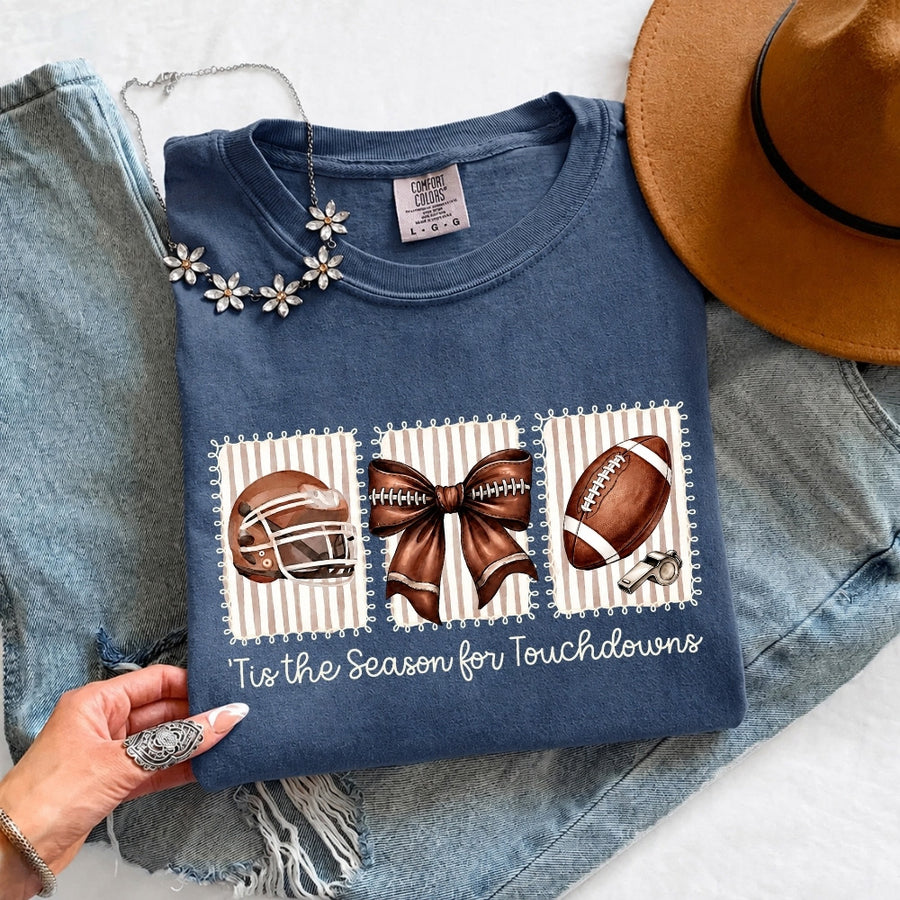 May include a Comfort Colors T-shirt featuring a 'Tis the Season for Touchdowns football-inspired design, perfect for football fans, game days, tailgates, and holiday gatherings.
