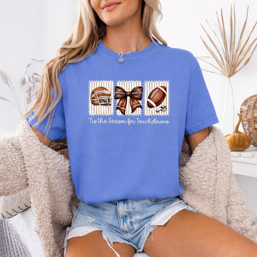 May include a Comfort Colors T-shirt featuring a 'Tis the Season for Touchdowns football-inspired design, perfect for football fans, game days, tailgates, and holiday gatherings.