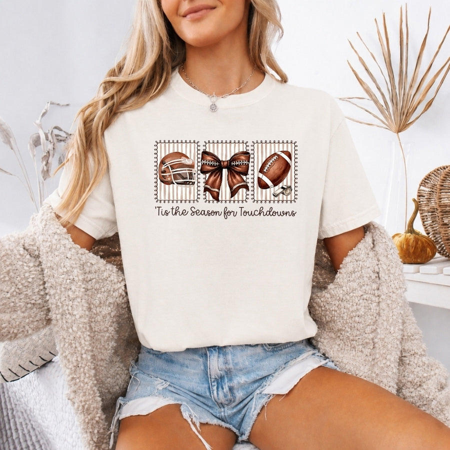 May include a Comfort Colors T-shirt featuring a 'Tis the Season for Touchdowns football-inspired design, perfect for football fans, game days, tailgates, and holiday gatherings.