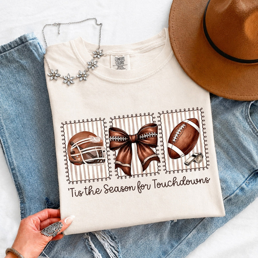 May include a Comfort Colors T-shirt featuring a 'Tis the Season for Touchdowns football-inspired design, perfect for football fans, game days, tailgates, and holiday gatherings.