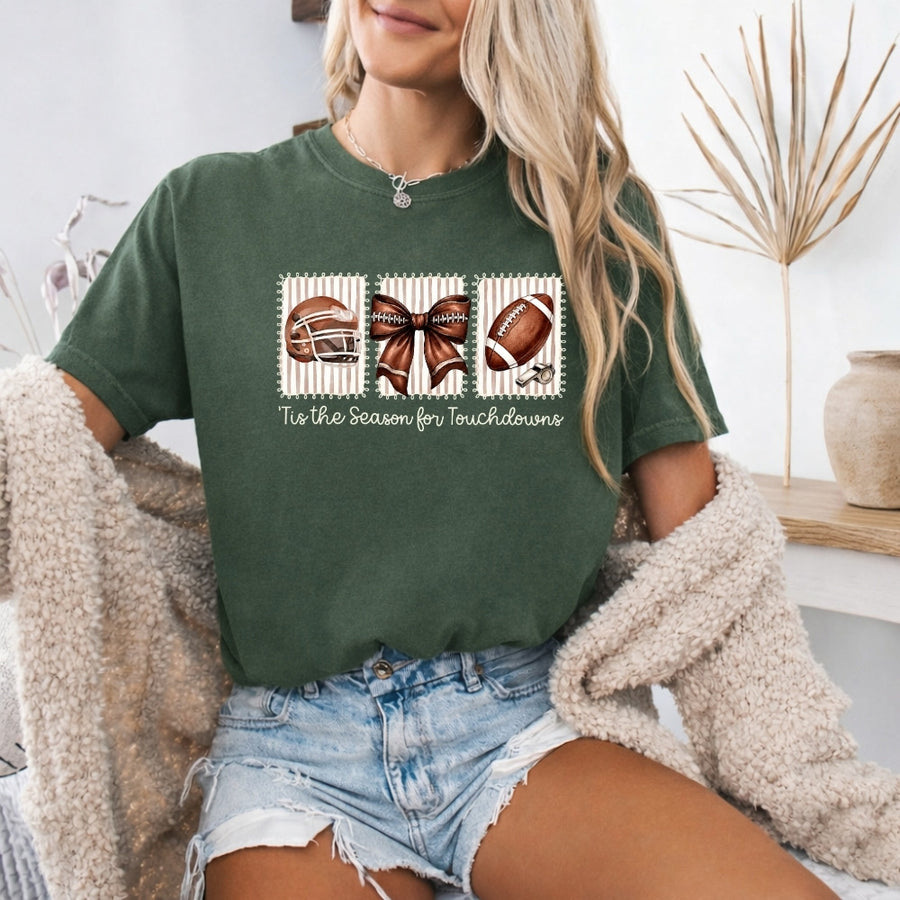 May include a Comfort Colors T-shirt featuring a 'Tis the Season for Touchdowns football-inspired design, perfect for football fans, game days, tailgates, and holiday gatherings.