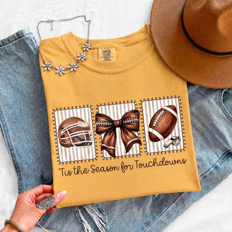May include a Comfort Colors T-shirt featuring a 'Tis the Season for Touchdowns football-inspired design, perfect for football fans, game days, tailgates, and holiday gatherings.