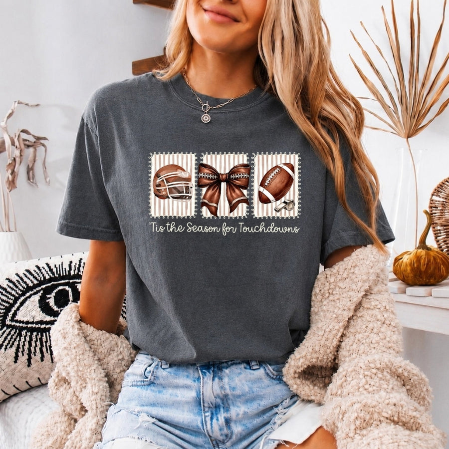 May include a Comfort Colors T-shirt featuring a 'Tis the Season for Touchdowns football-inspired design, perfect for football fans, game days, tailgates, and holiday gatherings.
