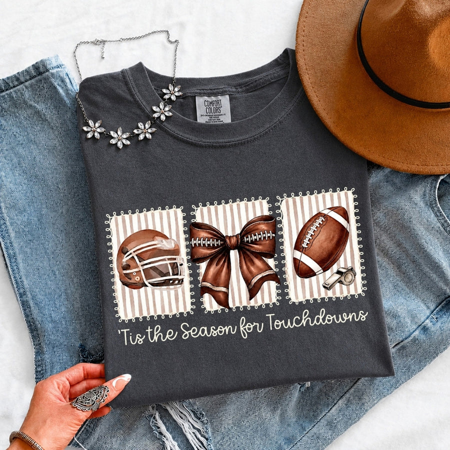 May include a Comfort Colors T-shirt featuring a 'Tis the Season for Touchdowns football-inspired design, perfect for football fans, game days, tailgates, and holiday gatherings.