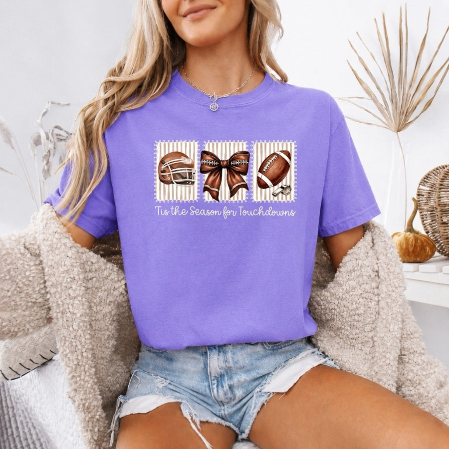 May include a Comfort Colors T-shirt featuring a 'Tis the Season for Touchdowns football-inspired design, perfect for football fans, game days, tailgates, and holiday gatherings.