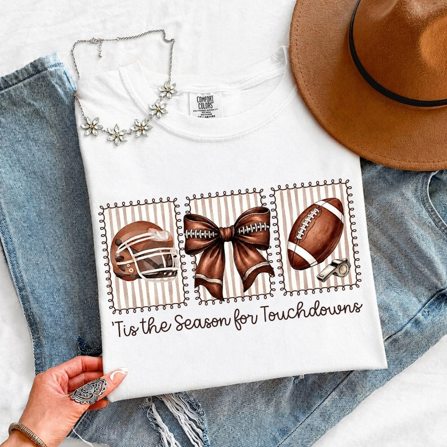 May include a Comfort Colors T-shirt featuring a 'Tis the Season for Touchdowns football-inspired design, perfect for football fans, game days, tailgates, and holiday gatherings.