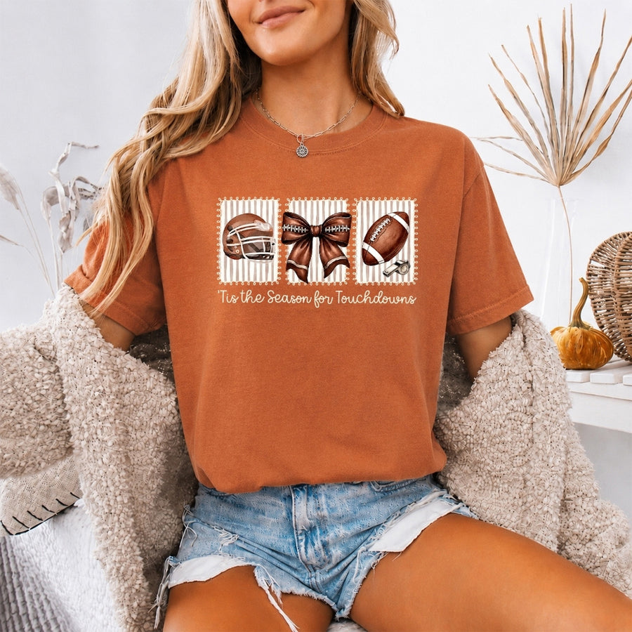 May include a Comfort Colors T-shirt featuring a 'Tis the Season for Touchdowns football-inspired design, perfect for football fans, game days, tailgates, and holiday gatherings.