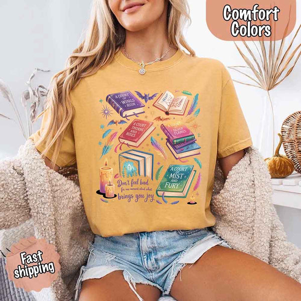 May include colorful illustrated books from the “A Court of Thorns and Roses” series surrounded by feathers, candles, and stars, with the quote “Don’t feel bad for one moment about what brings you joy,” celebrating fantasy fiction and book lover pride.