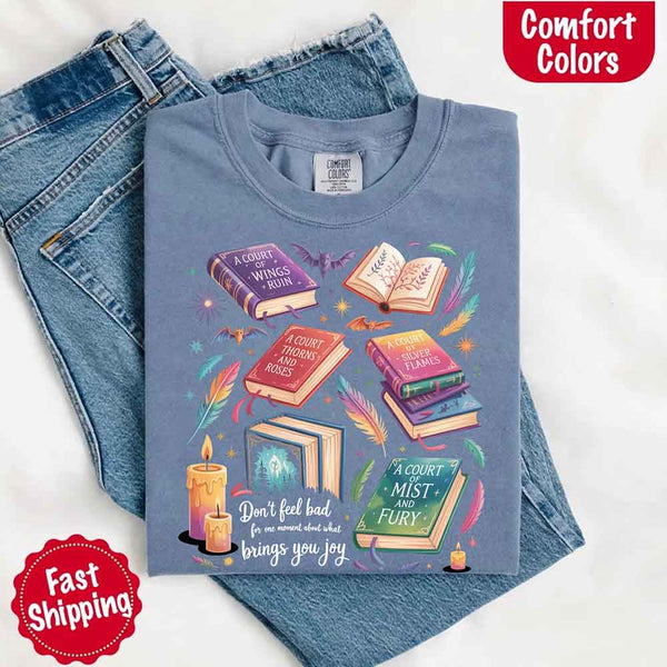 May include colorful illustrated books from the “A Court of Thorns and Roses” series surrounded by feathers, candles, and stars, with the quote “Don’t feel bad for one moment about what brings you joy,” celebrating fantasy fiction and book lover pride.