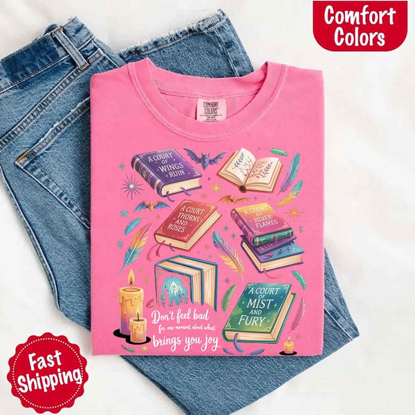 May include colorful illustrated books from the “A Court of Thorns and Roses” series surrounded by feathers, candles, and stars, with the quote “Don’t feel bad for one moment about what brings you joy,” celebrating fantasy fiction and book lover pride.