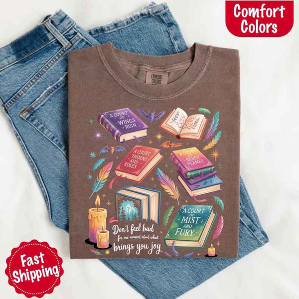 May include colorful illustrated books from the “A Court of Thorns and Roses” series surrounded by feathers, candles, and stars, with the quote “Don’t feel bad for one moment about what brings you joy,” celebrating fantasy fiction and book lover pride.