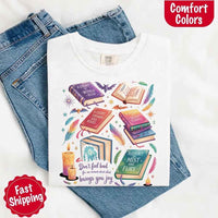 May include colorful illustrated books from the “A Court of Thorns and Roses” series surrounded by feathers, candles, and stars, with the quote “Don’t feel bad for one moment about what brings you joy,” celebrating fantasy fiction and book lover pride.