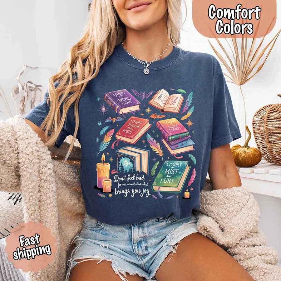 May include colorful illustrated books from the “A Court of Thorns and Roses” series surrounded by feathers, candles, and stars, with the quote “Don’t feel bad for one moment about what brings you joy,” celebrating fantasy fiction and book lover pride.