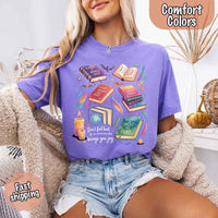 May include colorful illustrated books from the “A Court of Thorns and Roses” series surrounded by feathers, candles, and stars, with the quote “Don’t feel bad for one moment about what brings you joy,” celebrating fantasy fiction and book lover pride.