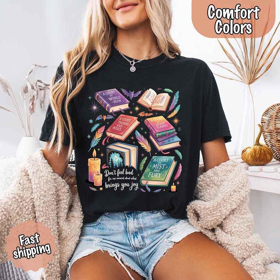 May include colorful illustrated books from the “A Court of Thorns and Roses” series surrounded by feathers, candles, and stars, with the quote “Don’t feel bad for one moment about what brings you joy,” celebrating fantasy fiction and book lover pride.