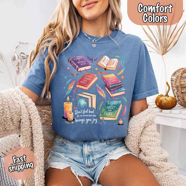 May include colorful illustrated books from the “A Court of Thorns and Roses” series surrounded by feathers, candles, and stars, with the quote “Don’t feel bad for one moment about what brings you joy,” celebrating fantasy fiction and book lover pride.
