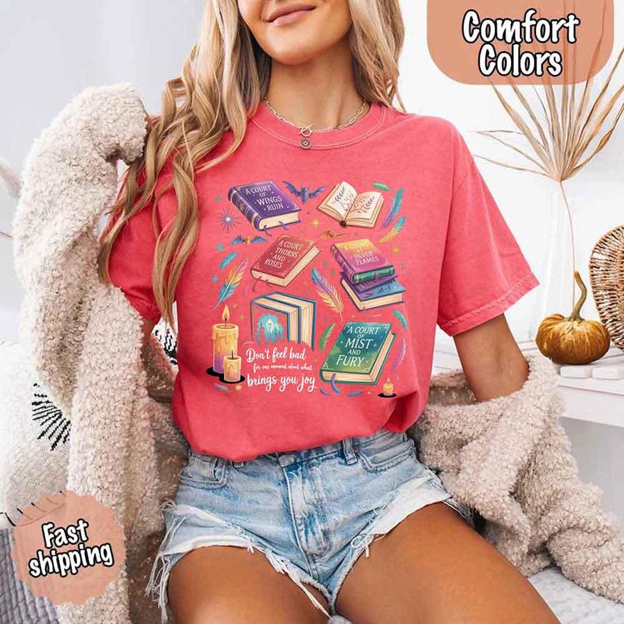 May include colorful illustrated books from the “A Court of Thorns and Roses” series surrounded by feathers, candles, and stars, with the quote “Don’t feel bad for one moment about what brings you joy,” celebrating fantasy fiction and book lover pride.