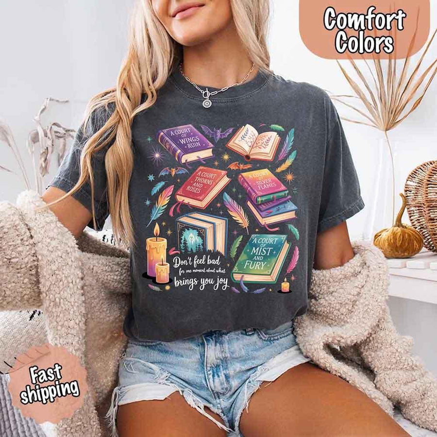 May include colorful illustrated books from the “A Court of Thorns and Roses” series surrounded by feathers, candles, and stars, with the quote “Don’t feel bad for one moment about what brings you joy,” celebrating fantasy fiction and book lover pride.