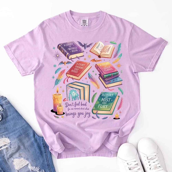 May include colorful illustrated books from the “A Court of Thorns and Roses” series surrounded by feathers, candles, and stars, with the quote “Don’t feel bad for one moment about what brings you joy,” celebrating fantasy fiction and book lover pride.