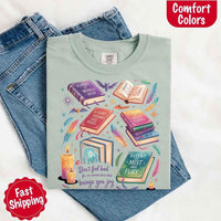 May include colorful illustrated books from the “A Court of Thorns and Roses” series surrounded by feathers, candles, and stars, with the quote “Don’t feel bad for one moment about what brings you joy,” celebrating fantasy fiction and book lover pride.