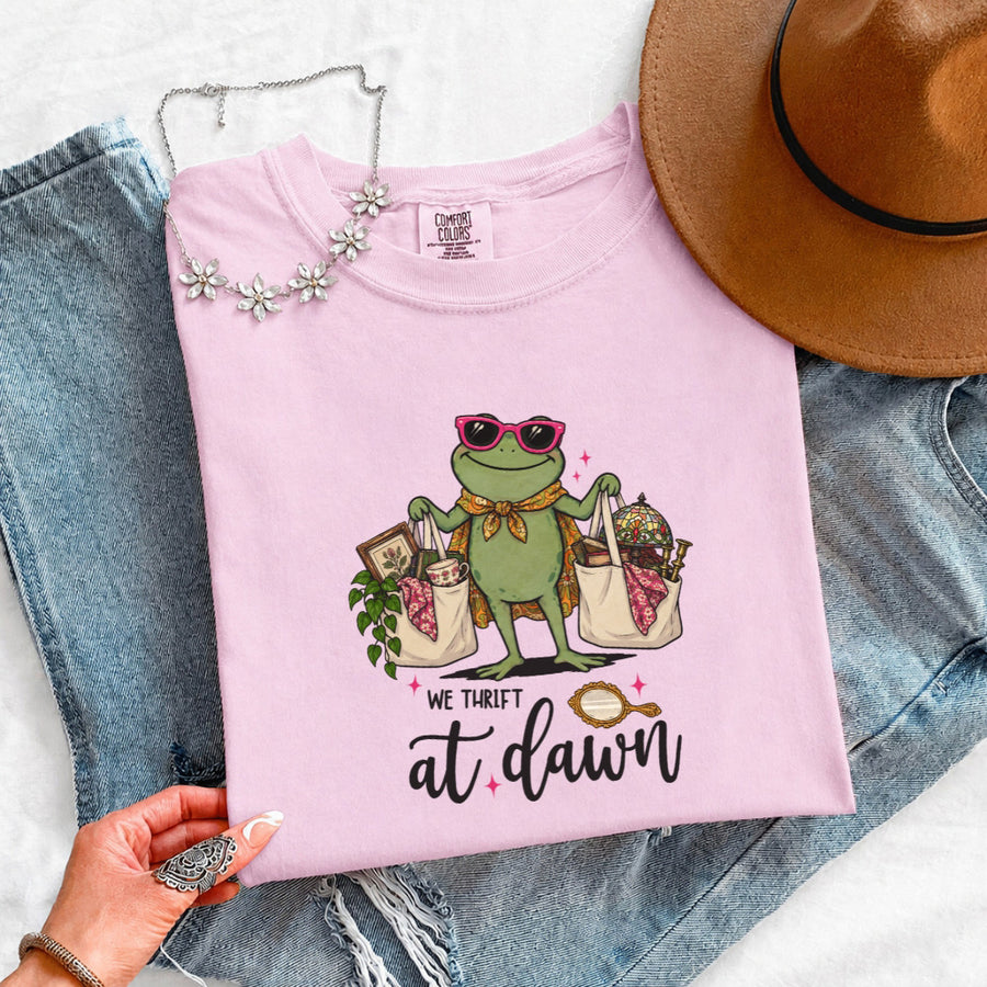 May include a We Thrift at Dawn Comfort Colors T-Shirt featuring a playful thrift-inspired statement design.