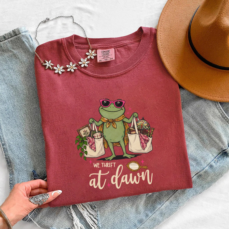 May include a We Thrift at Dawn Comfort Colors T-Shirt featuring a playful thrift-inspired statement design.