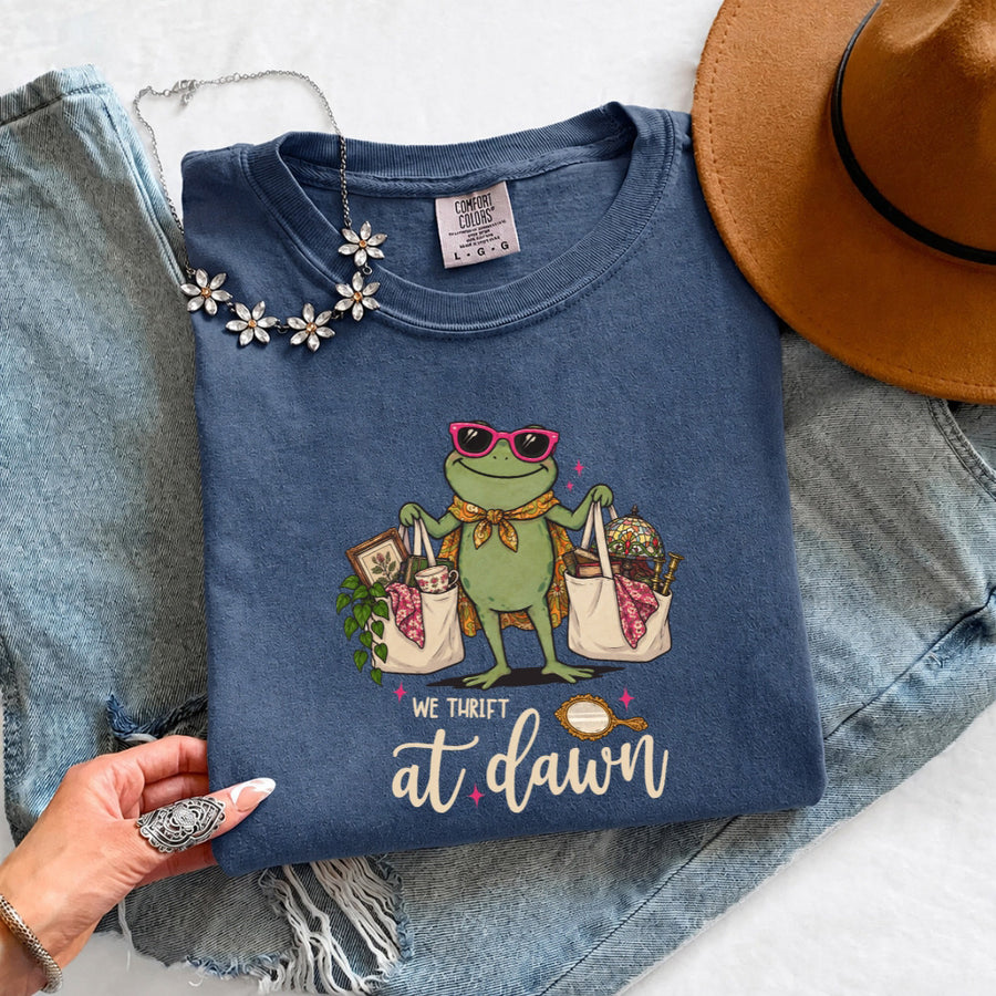 May include a We Thrift at Dawn Comfort Colors T-Shirt featuring a playful thrift-inspired statement design.