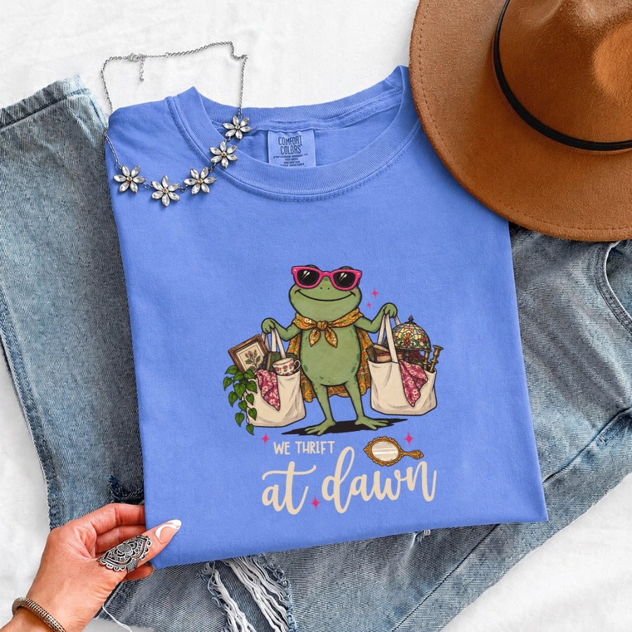 May include a We Thrift at Dawn Comfort Colors T-Shirt featuring a playful thrift-inspired statement design.