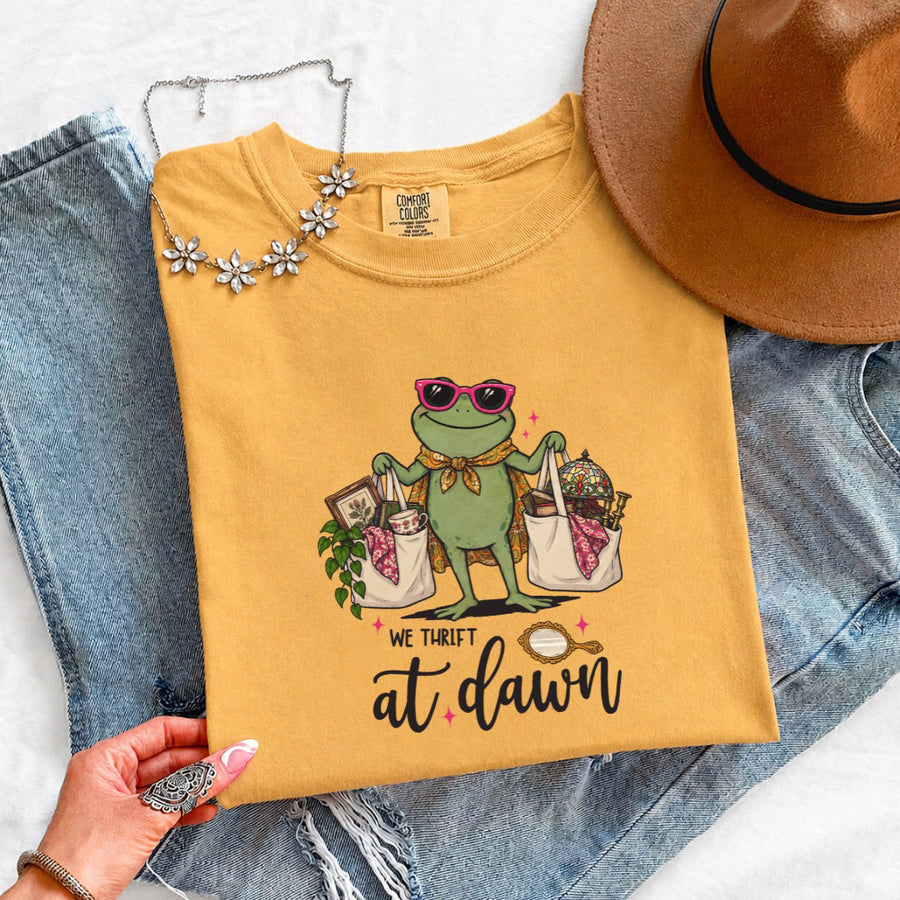 May include a We Thrift at Dawn Comfort Colors T-Shirt featuring a playful thrift-inspired statement design.