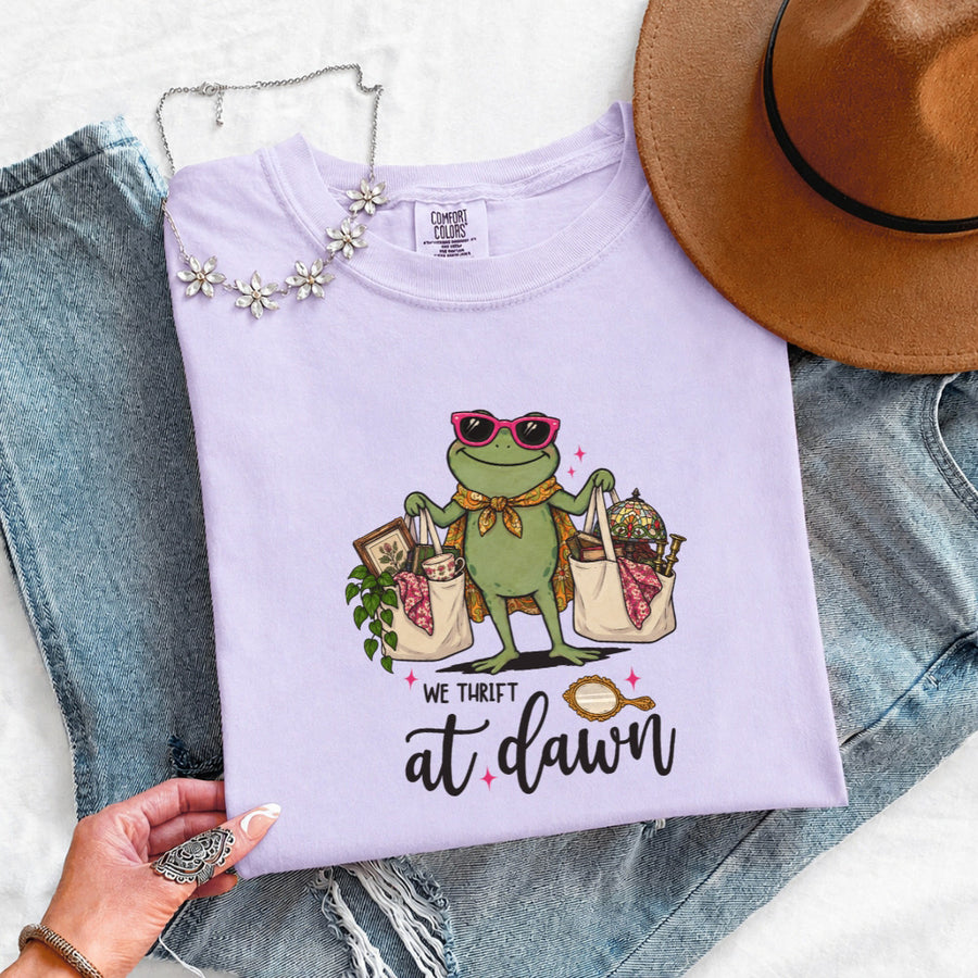 May include a We Thrift at Dawn Comfort Colors T-Shirt featuring a playful thrift-inspired statement design.