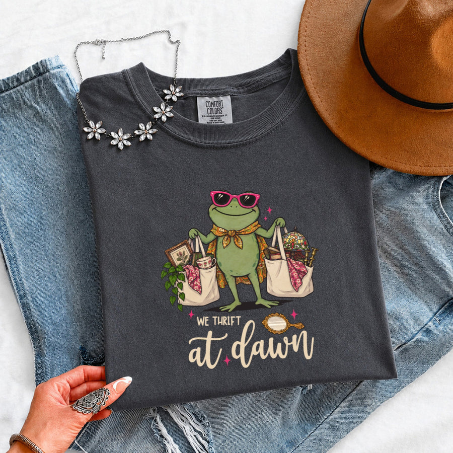 May include a We Thrift at Dawn Comfort Colors T-Shirt featuring a playful thrift-inspired statement design.