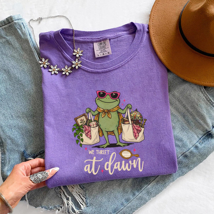 May include a We Thrift at Dawn Comfort Colors T-Shirt featuring a playful thrift-inspired statement design.