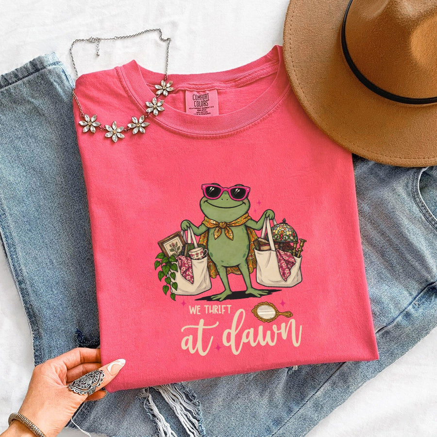 May include a We Thrift at Dawn Comfort Colors T-Shirt featuring a playful thrift-inspired statement design.