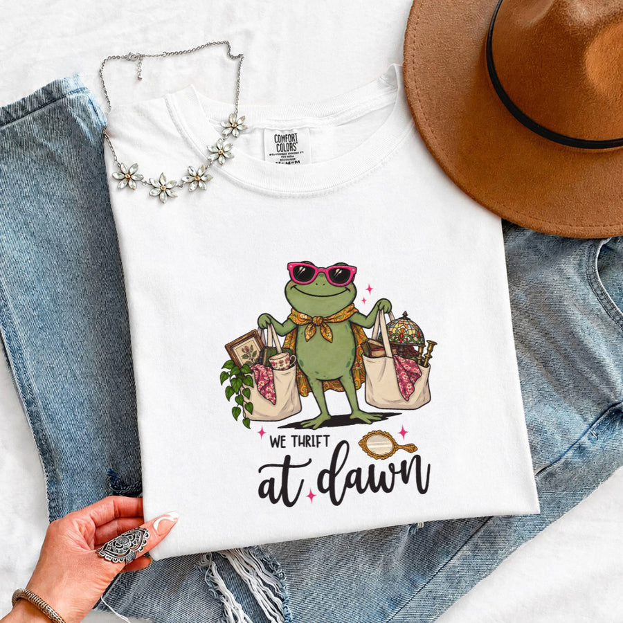 May include a We Thrift at Dawn Comfort Colors T-Shirt featuring a playful thrift-inspired statement design.
