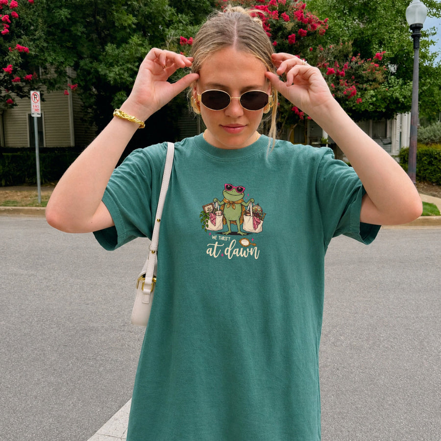 May include a We Thrift at Dawn Comfort Colors T-Shirt featuring a playful thrift-inspired statement design.