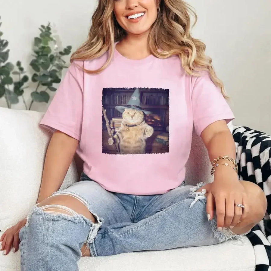 May include a Halloween t-shirt with a funny wizard cat meme graphic, combining magical and spooky design elements for cat lovers.