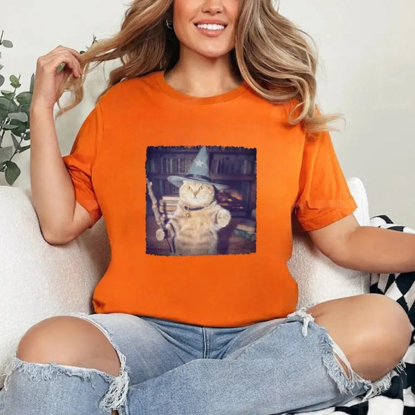 May include a Halloween t-shirt with a funny wizard cat meme graphic, combining magical and spooky design elements for cat lovers.