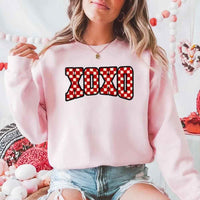 May include a crewneck sweatshirt with an XOXO checkered design featuring a soft, furry-style printed texture.