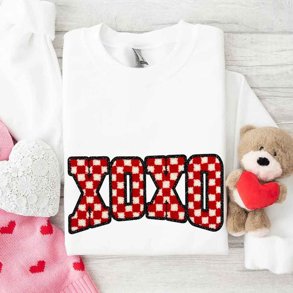 May include a crewneck sweatshirt with an XOXO checkered design featuring a soft, furry-style printed texture.