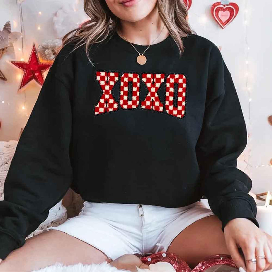 May include a crewneck sweatshirt with an XOXO checkered design featuring a soft, furry-style printed texture.